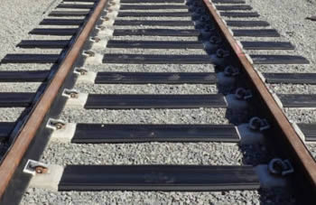a railroad track with crossing tie pads